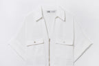 Dettaglio camicia bianca - zip frontale argento e tasche con bottone metallico